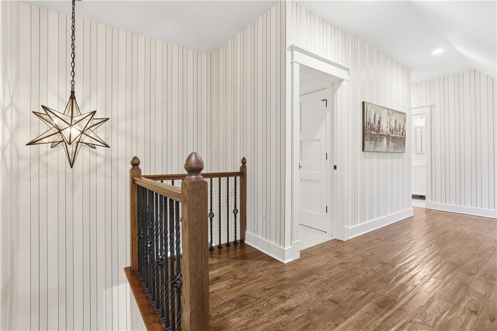 411 Woodland Road Sewickley, PA 15143 - Photo 23 of 46 a view of a hallway with wooden floor and a bathroom