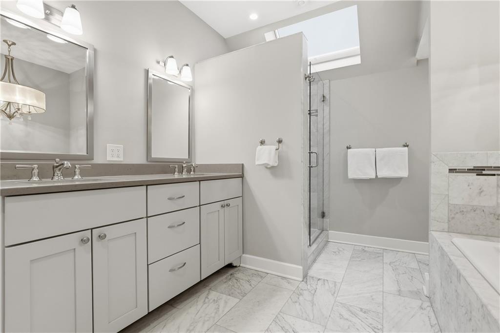 411 Woodland Road Sewickley, PA 15143 - Photo 29 of 46 a spacious bathroom with a granite countertop sink a mirror and a