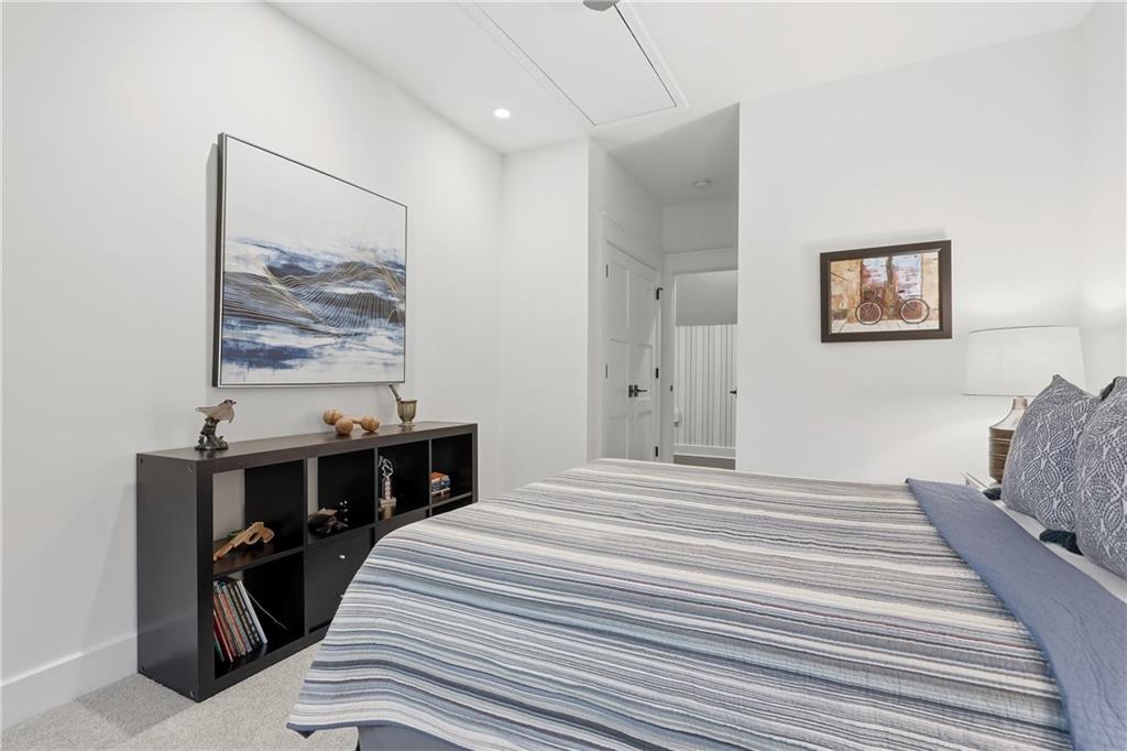 411 Woodland Road Sewickley, PA 15143 - Photo 31 of 46 a bedroom with a bed and a wall painting