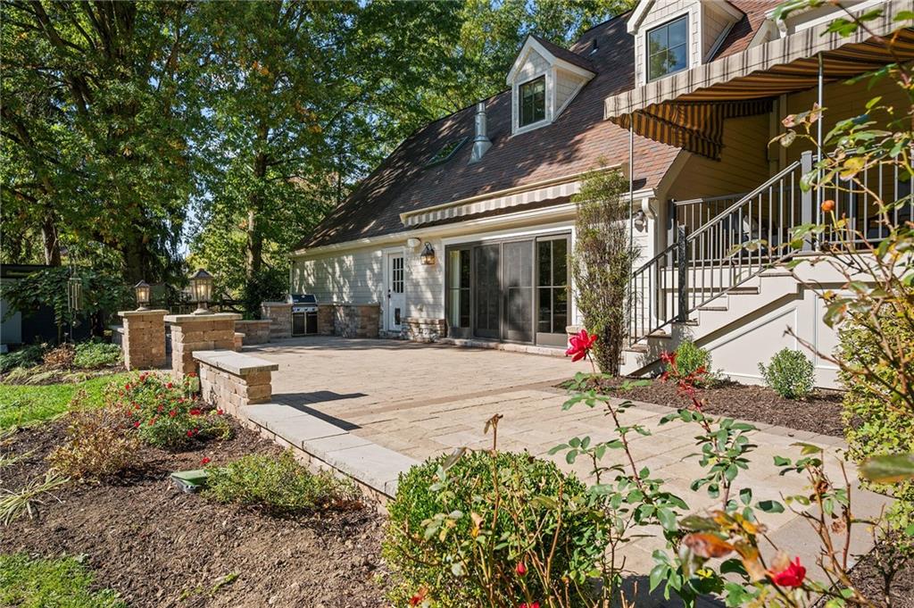 411 Woodland Road Sewickley, PA 15143 - Photo 42 of 46 a view of a white house with a small yard and plants