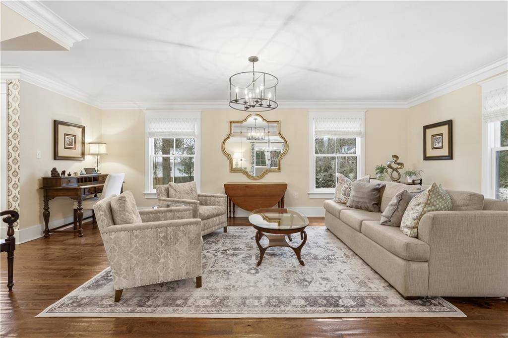 411 Woodland Road Sewickley, PA 15143 - Photo 8 of 46 a living room with fireplace furniture and a chandelier