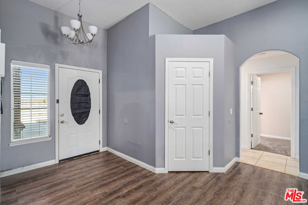 9516 Mendiburu Road California City, CA 93505 - Photo 13 of 32 wooden floor in an empty room with a window
