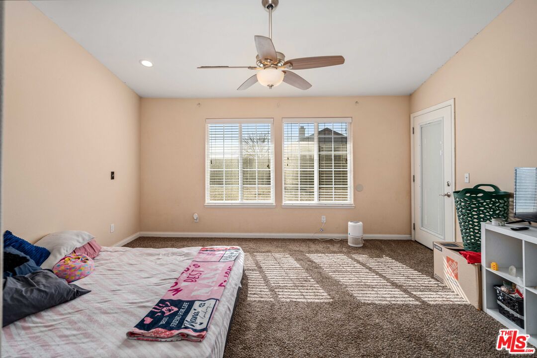 9516 Mendiburu Road California City, CA 93505 - Photo 16 of 32 a bedroom with bed and a window