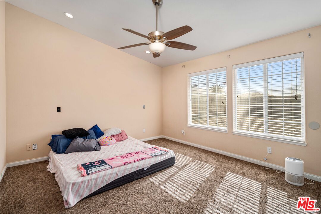 9516 Mendiburu Road California City, CA 93505 - Photo 17 of 32 a bedroom with a bed and a window