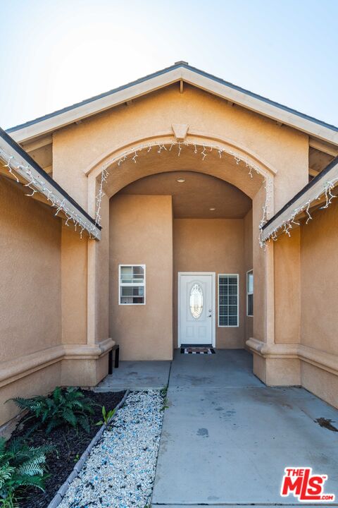 9516 Mendiburu Road California City, CA 93505 - Photo 2 of 32 a view of a house with a small yard