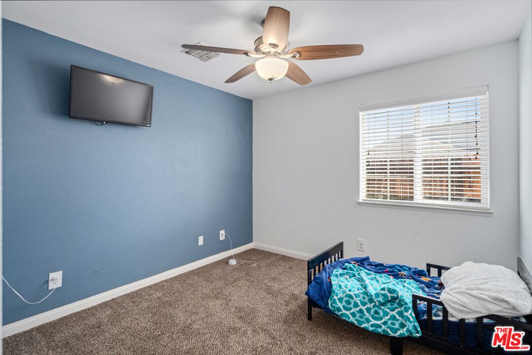 9516 Mendiburu Road California City, CA 93505 - Photo 21 of 32 a living room with furniture and a flat screen tv