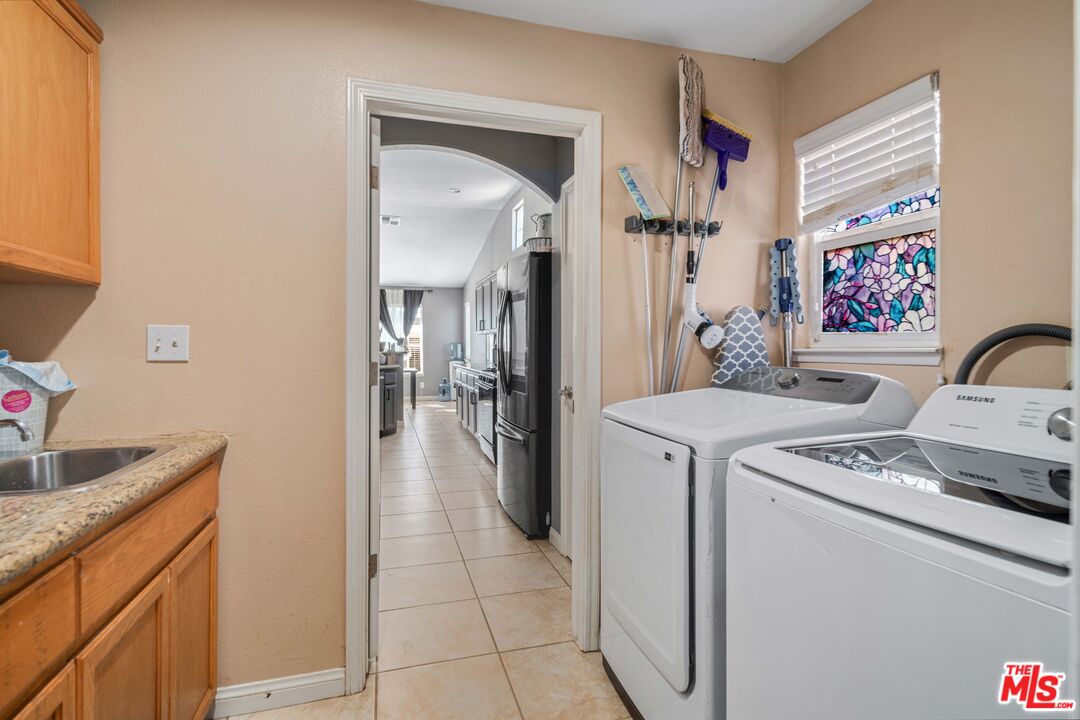 9516 Mendiburu Road California City, CA 93505 - Photo 24 of 32 a kitchen with a refrigerator sink and cabinets