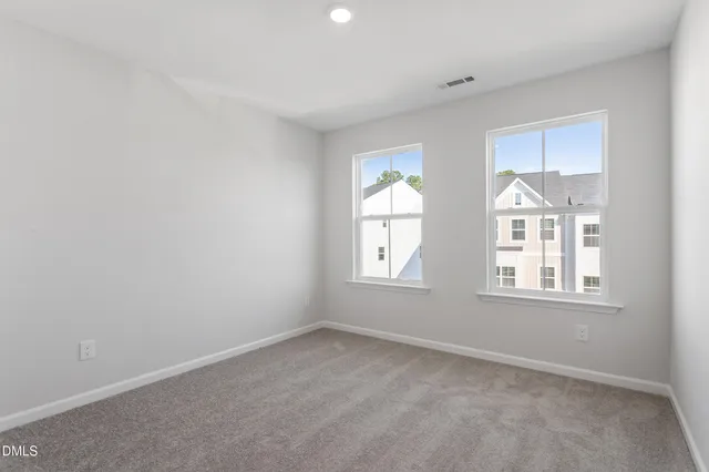 a view of a backyard with a garden and entertaining space