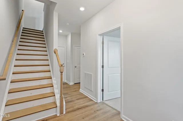 a large kitchen with granite countertop a sink a counter top space appliances and cabinets