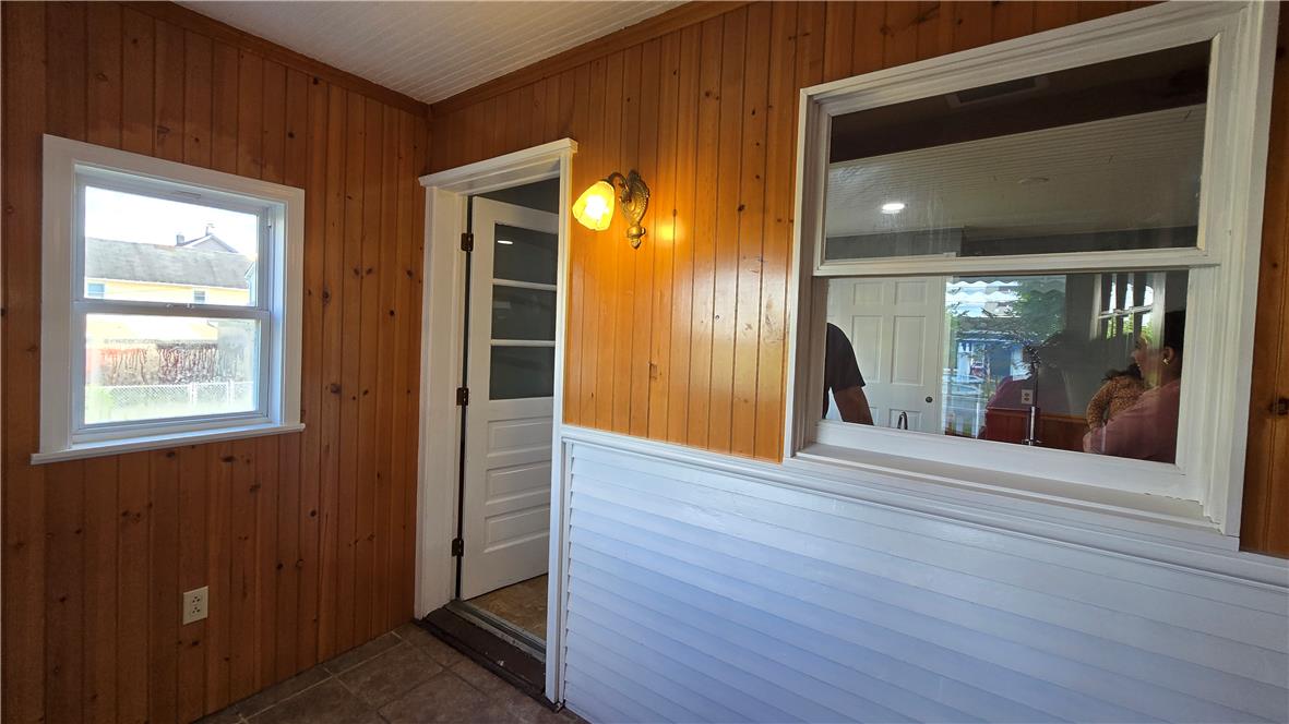 883 North Locust Street Hazleton, PA 18201 - Photo 40 of 83 A welcoming entryway with natural wood paneling and bright windows provides a rustic charm.