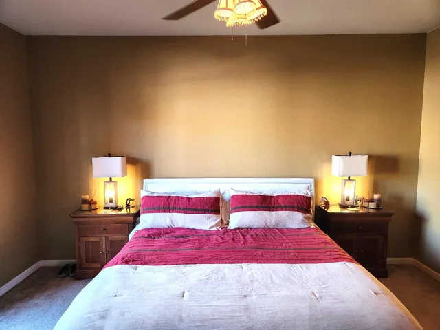 a bedroom with a bed and a night stand