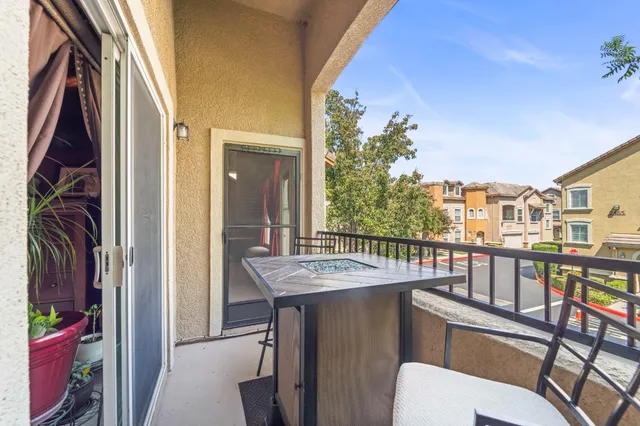 a balcony with furniture and a potted plant
