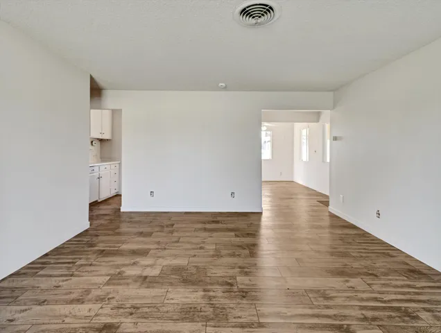 a view of a room with wooden floor