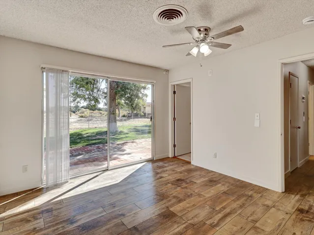 a view of a livingroom with a ceiling fan and window