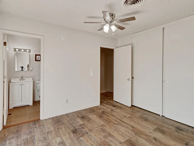 wooden floor in an empty room with a bathroom
