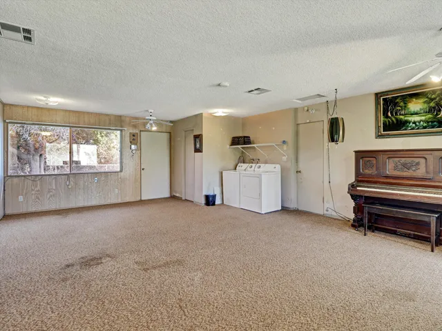 a view of a livingroom with furniture and a flat screen tv