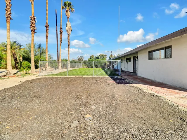 a view of small pool in front of house