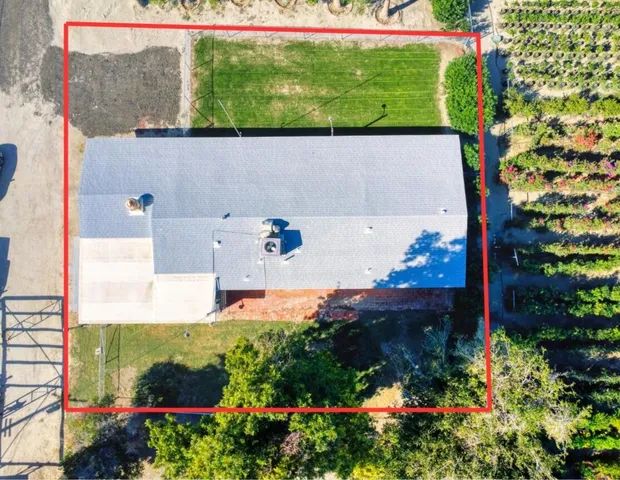 an aerial view of a house with a yard
