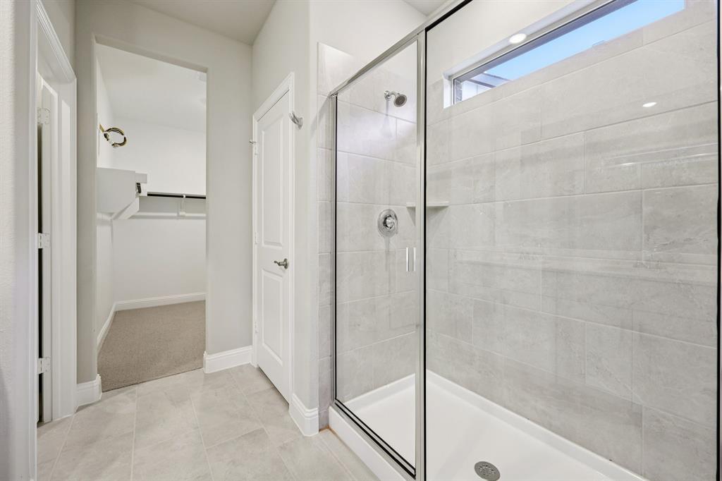 1721 Arches Road Anna, TX 75409 - Photo 25 of 39 a bathroom with a shower and a glass door