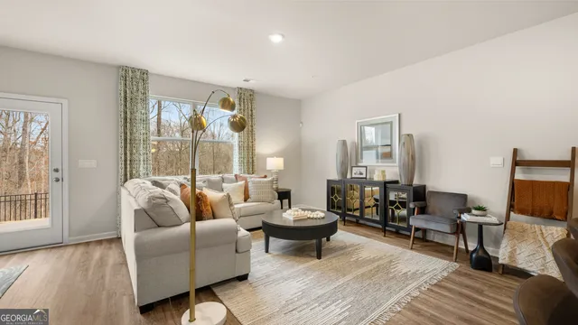 a living room with furniture and large windows