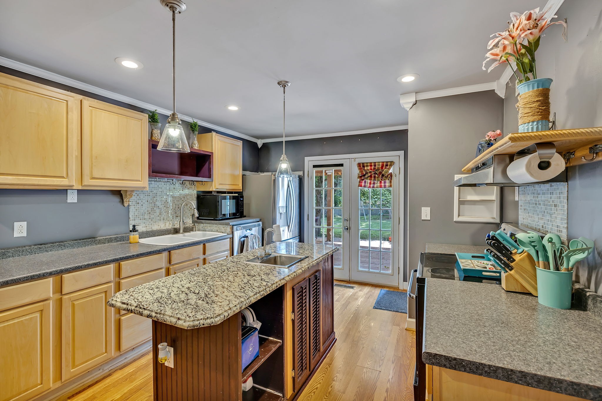 402 Springview Drive Franklin, TN 37064 - Photo 12 of 42 a kitchen with stainless steel appliances granite countertop sink stove refrigerator dining table and chairs