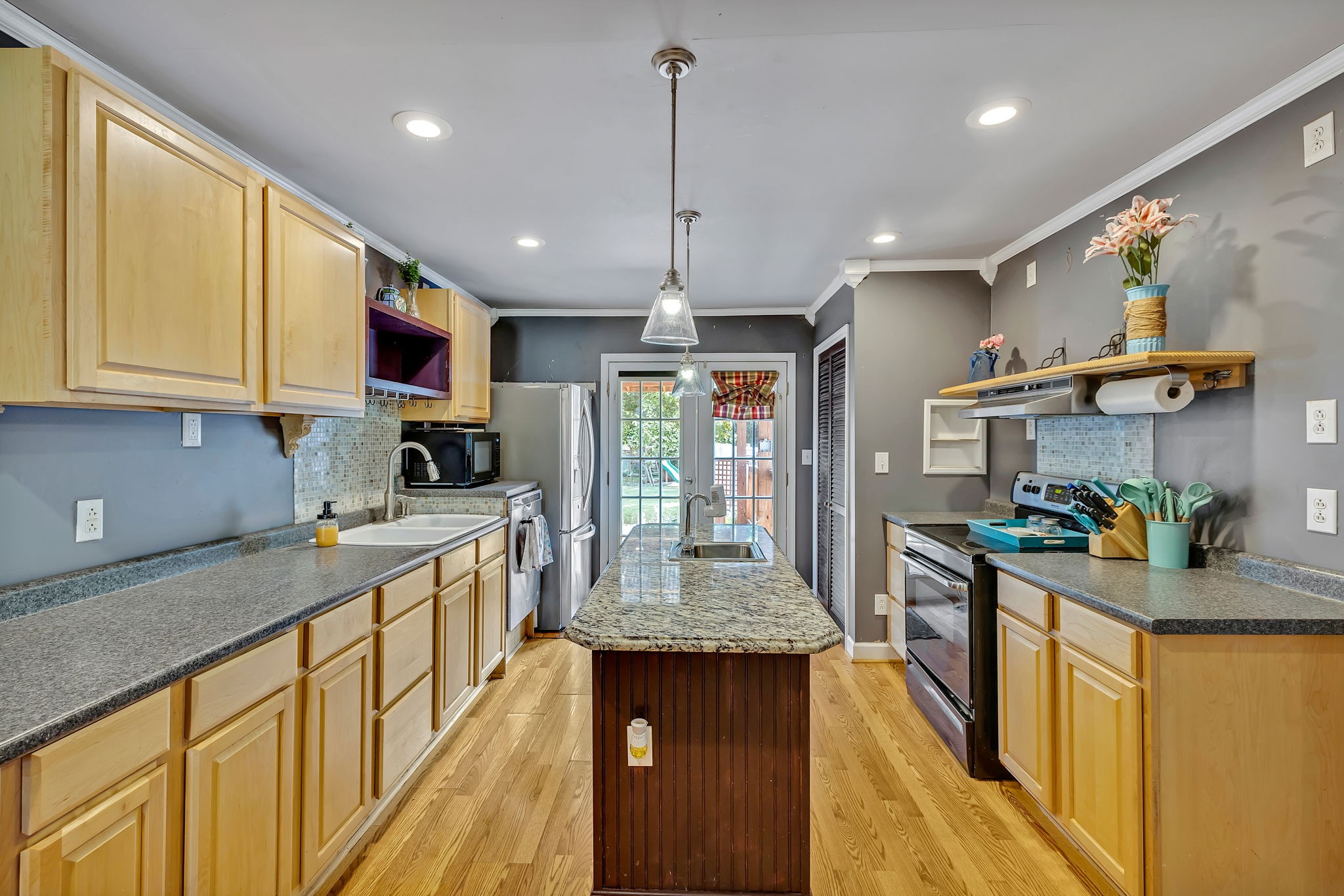 402 Springview Drive Franklin, TN 37064 - Photo 15 of 42 a kitchen with stainless steel appliances granite countertop sink stove top oven and cabinets