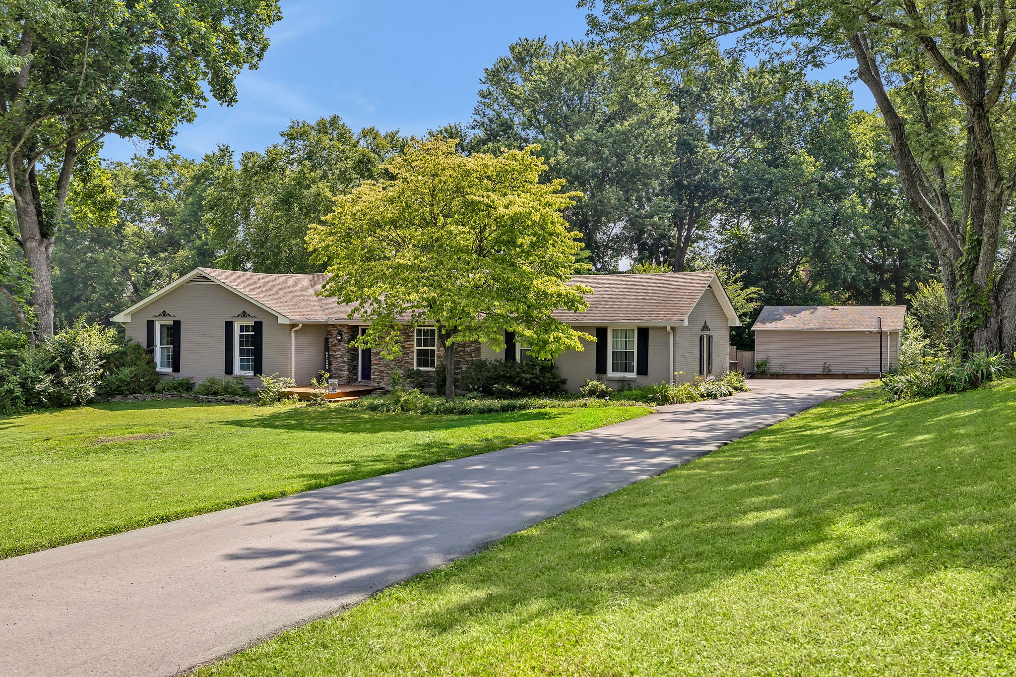 402 Springview Drive Franklin, TN 37064 - Photo 3 of 42 a front view of a house with garden