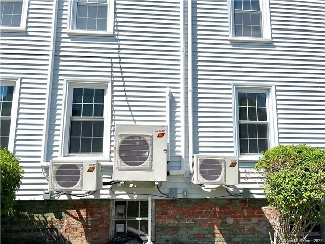 a view of a house with a small yard and sitting area