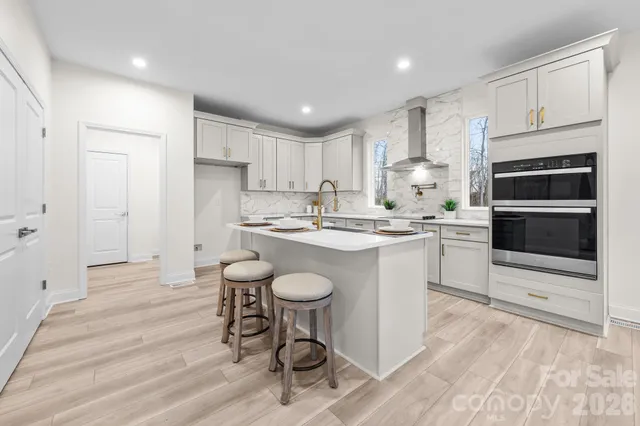 a kitchen with a sink stainless steel appliances and cabinets