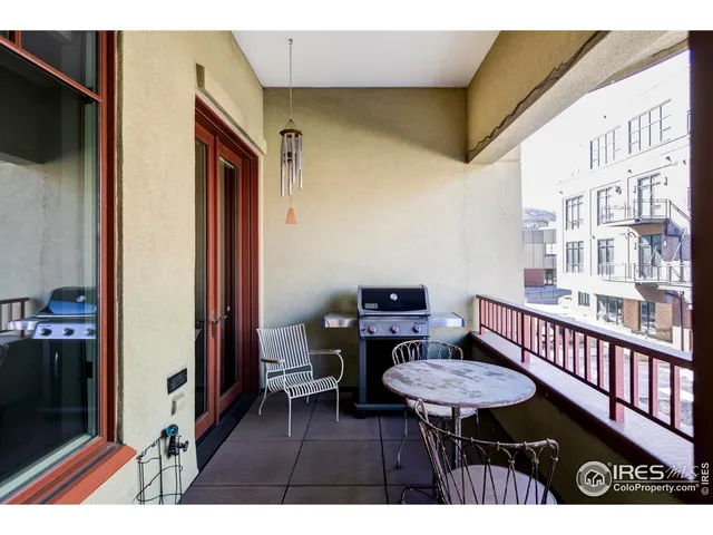 a balcony with table and chairs