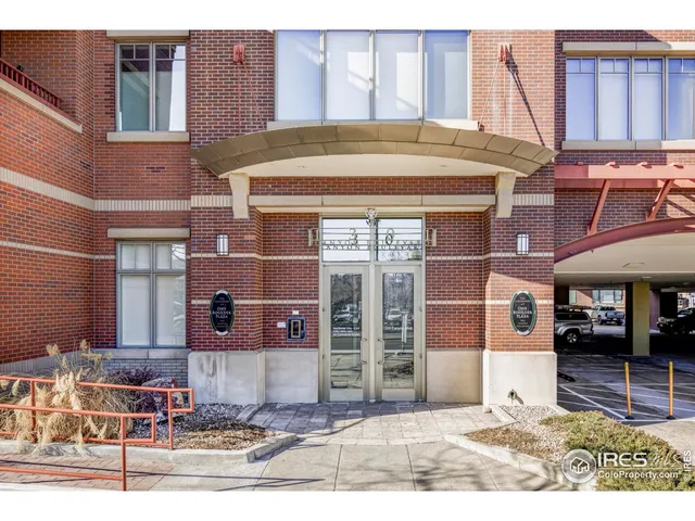 a view of a building with car parked