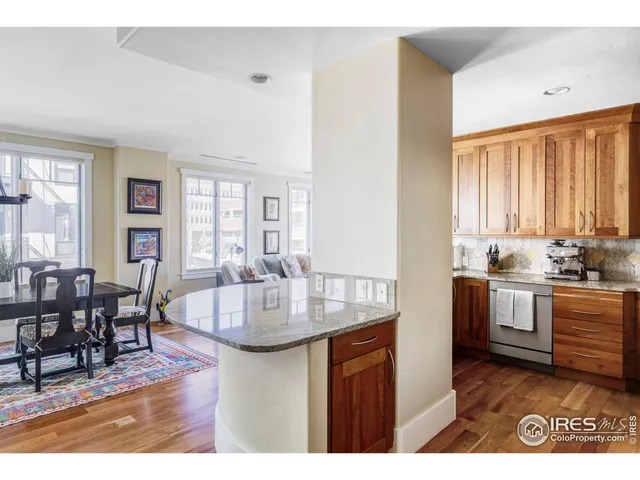 a kitchen with kitchen island granite countertop a sink table and chairs
