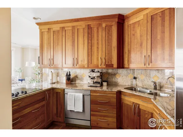 a kitchen with stainless steel appliances sink refrigerator and cabinets