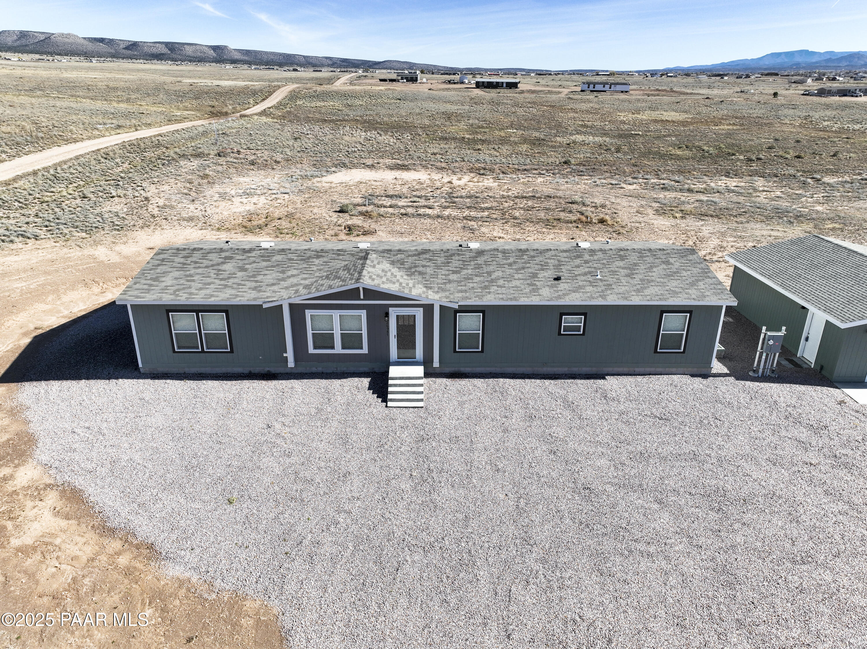 26987 North Chicory Way Paulden, AZ 86334 - Photo 31 of 44 a front view of a house next to a lake with a city view