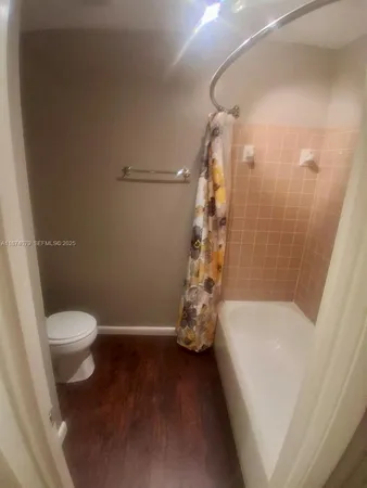 a bathroom with a toilet and shower