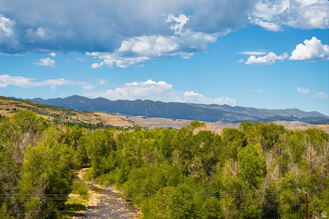 4347 South Bench Creek Road Kamas, UT 84036 - Photo 14 of 30 Mountainous landscape with expansive sky, a winding river, and abundant green trees