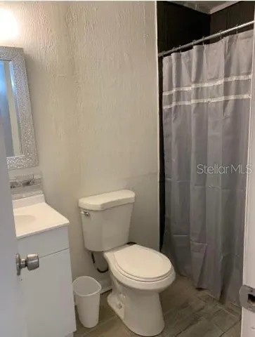 a white toilet sitting next to a bathroom sink