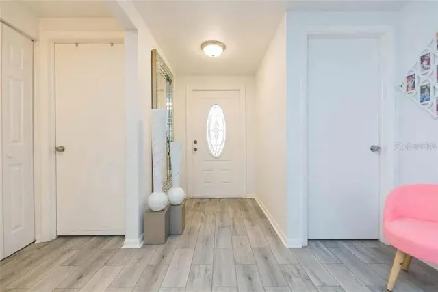 a view of a room with wooden floor and a window