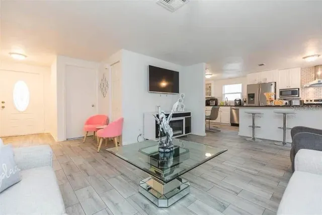 a living room with furniture and a flat screen tv