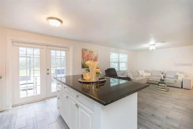 a kitchen with granite countertop a sink and a stove