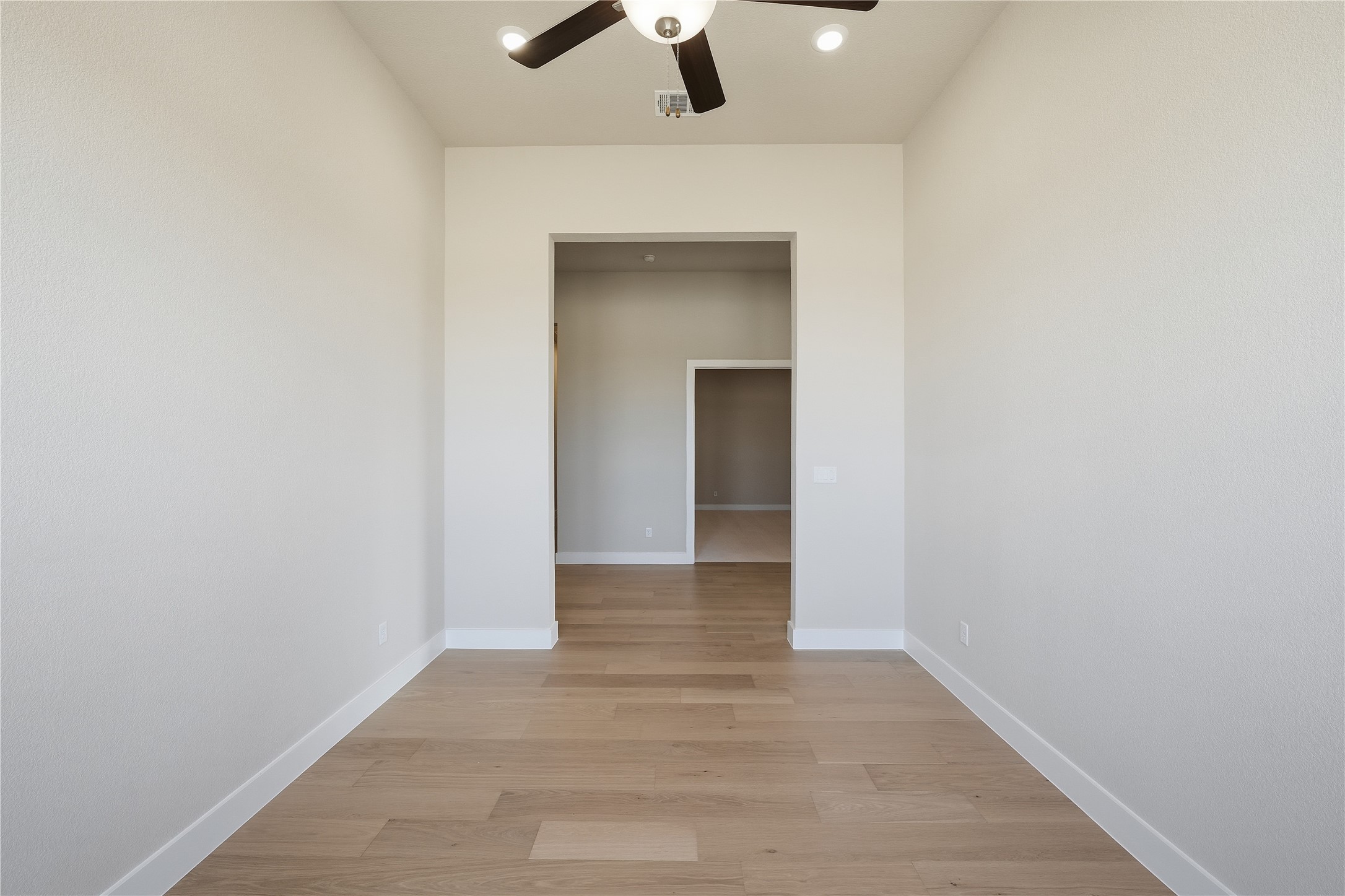1209 Doelling Drive Georgetown, TX 78633 - Photo 17 of 31 Empty room with light wood-style floors, ceiling fan, and recessed lighting