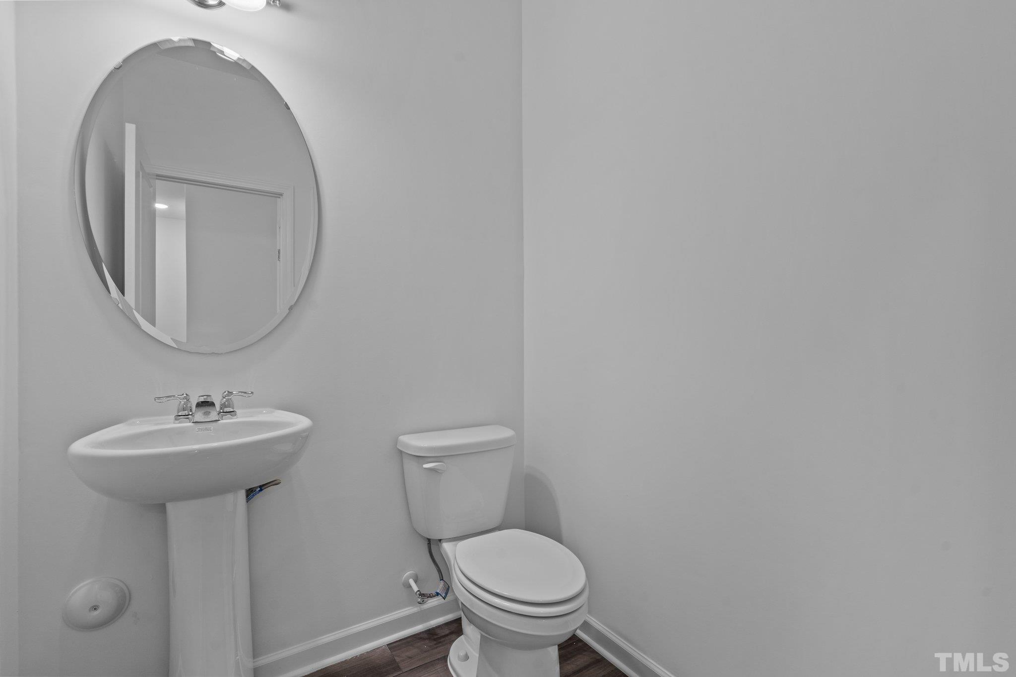 309 Spaight Acrs Way Wake Forest, NC 27587 - Photo 11 of 41 a bathroom with a toilet sink and mirror