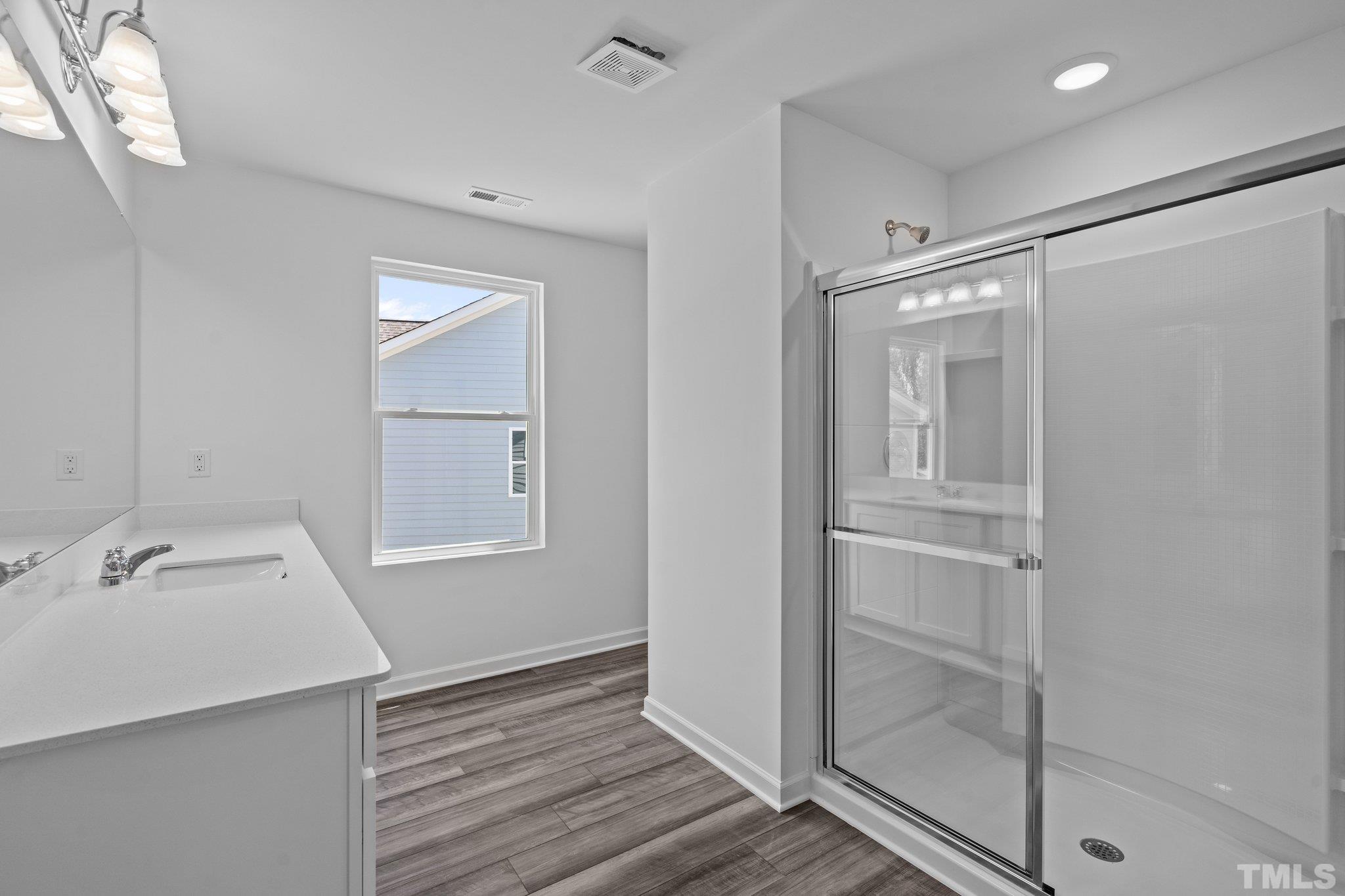 309 Spaight Acrs Way Wake Forest, NC 27587 - Photo 17 of 41 a bathroom with a shower sink and mirror