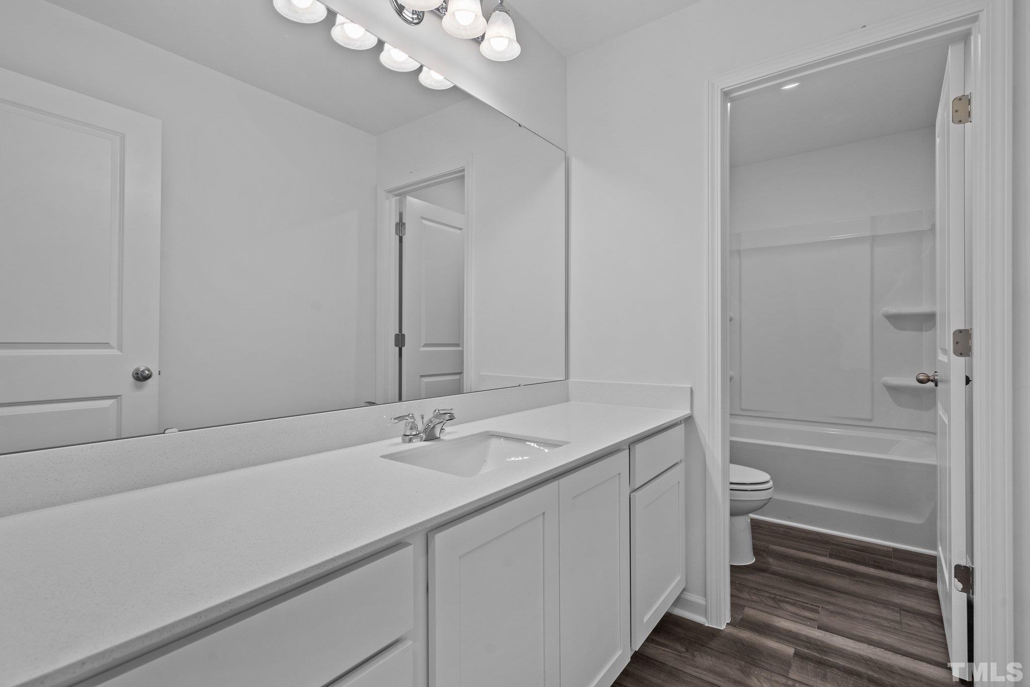 309 Spaight Acrs Way Wake Forest, NC 27587 - Photo 21 of 41 a bathroom with a sink a toilet and shower