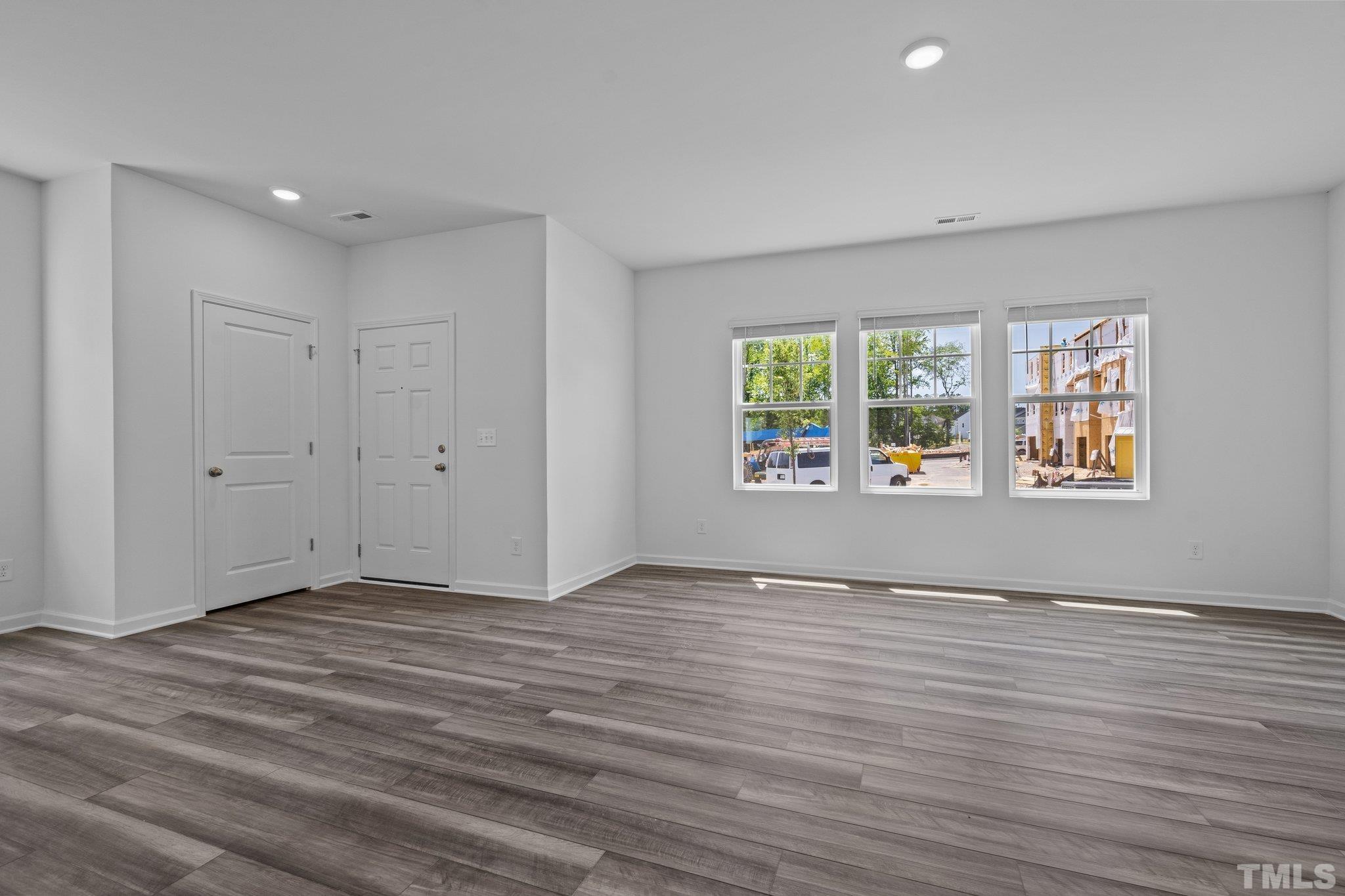309 Spaight Acrs Way Wake Forest, NC 27587 - Photo 3 of 41 a view of an empty room with wooden floor and a window