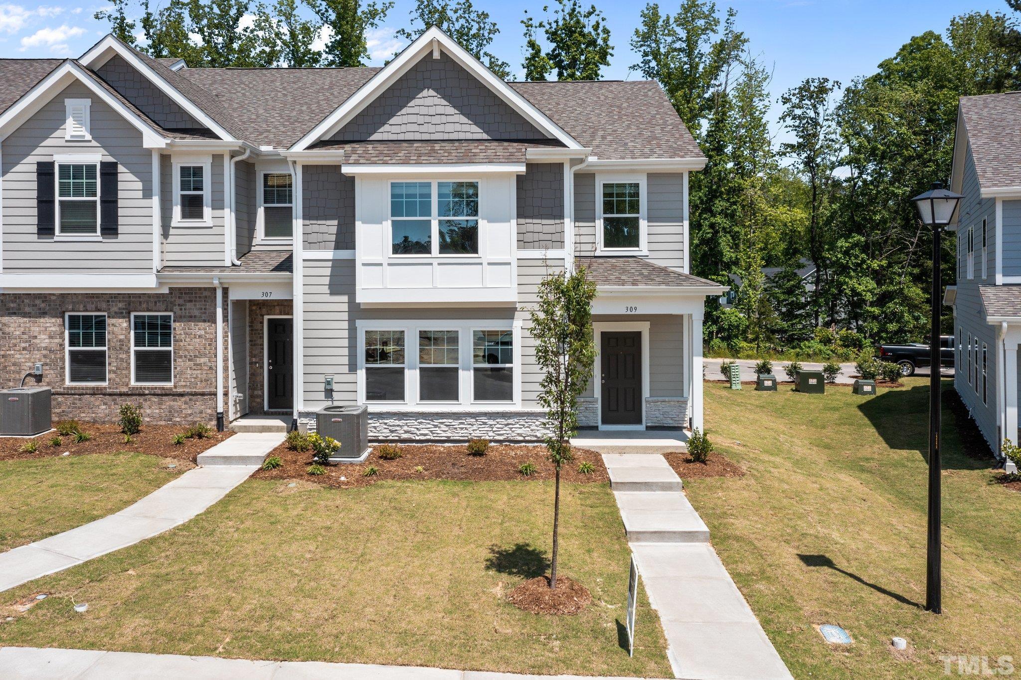 309 Spaight Acrs Way Wake Forest, NC 27587 - Photo 31 of 41 a front view of a house with a yard