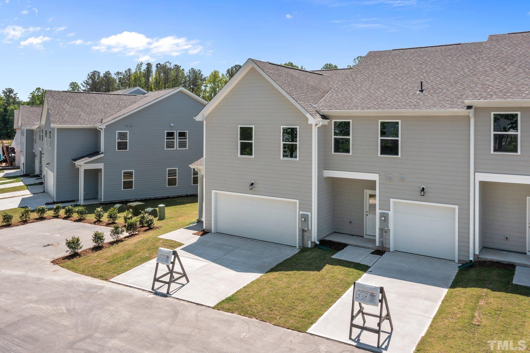 309 Spaight Acrs Way Wake Forest, NC 27587 - Photo 36 of 41 a view of a white house with a yard and furniture