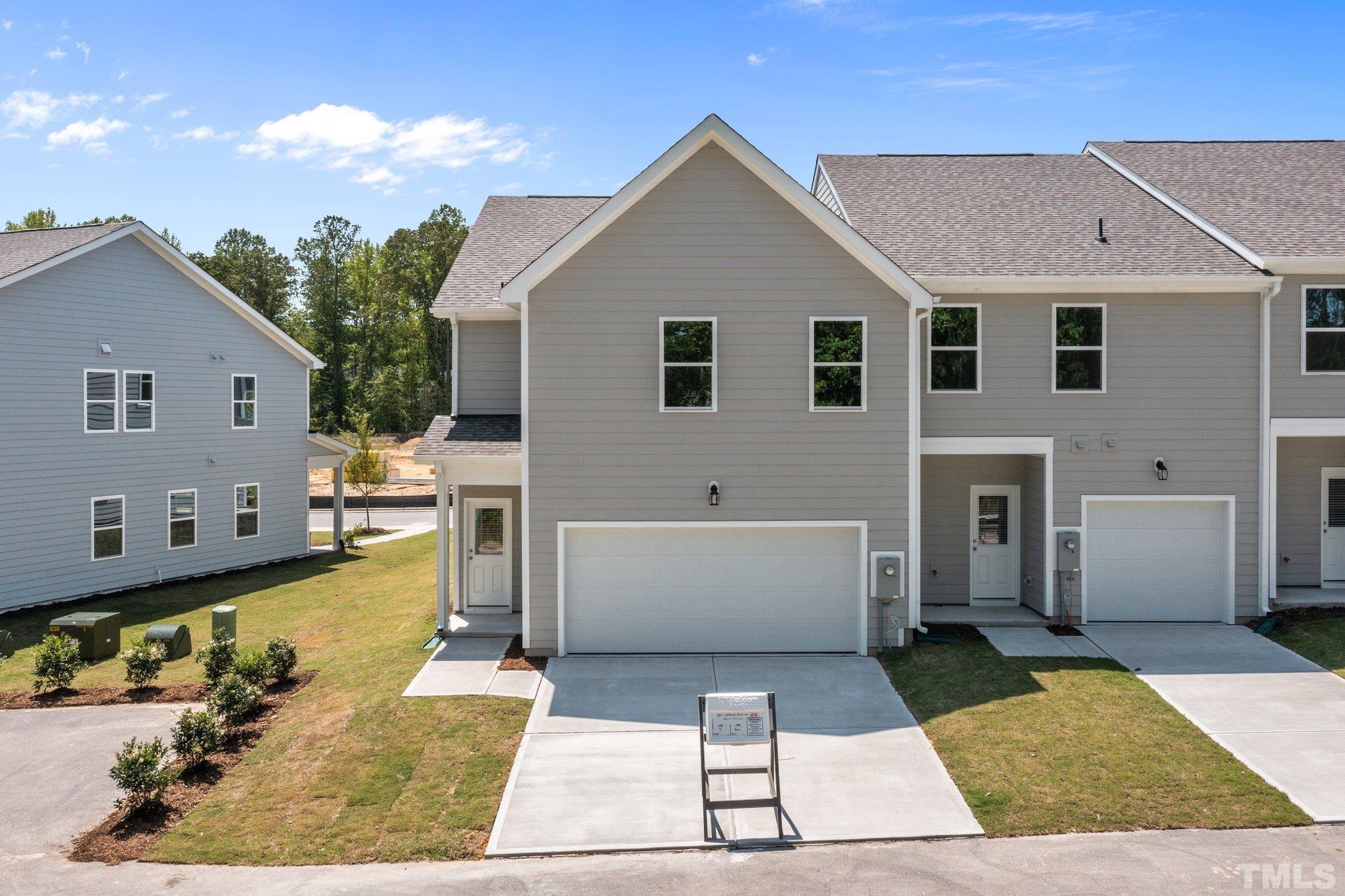 309 Spaight Acrs Way Wake Forest, NC 27587 - Photo 37 of 41 a view of a white house with swimming pool in front of it
