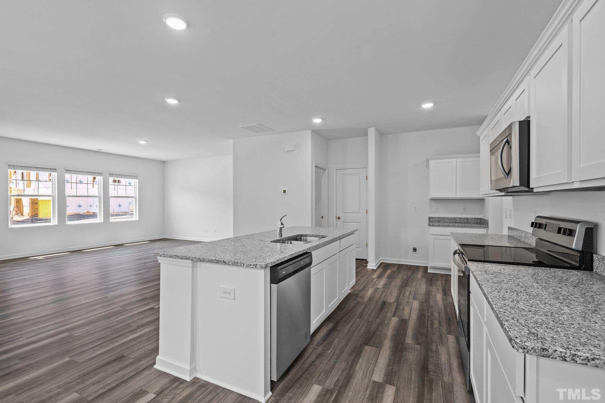 309 Spaight Acrs Way Wake Forest, NC 27587 - Photo 8 of 41 a kitchen with stainless steel appliances granite countertop a sink stove and cabinets
