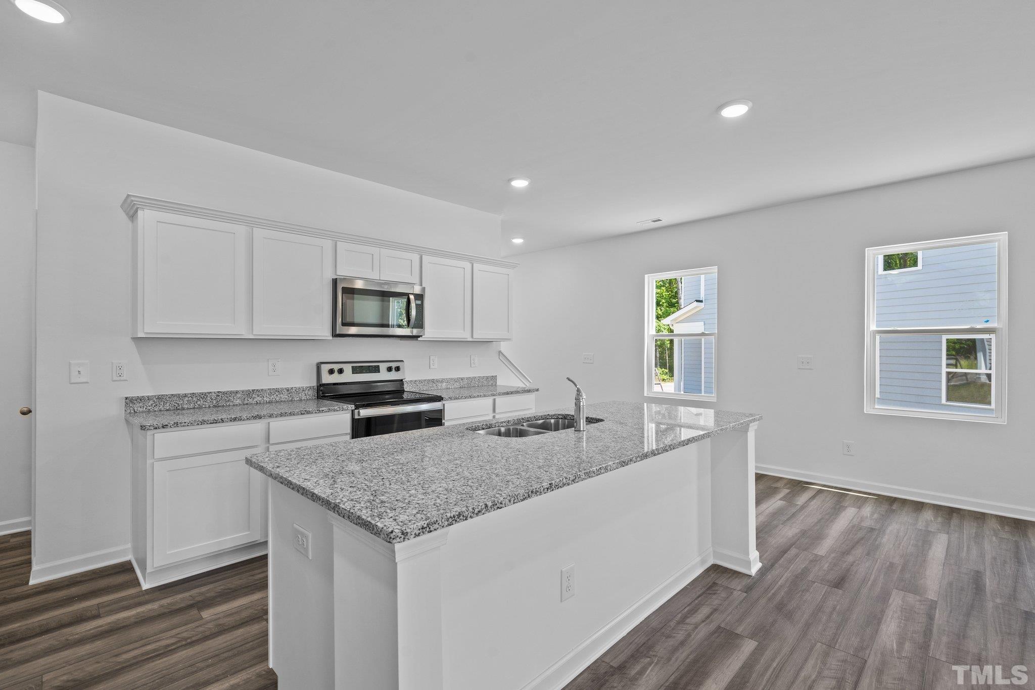 309 Spaight Acrs Way Wake Forest, NC 27587 - Photo 10 of 41 a kitchen with granite countertop a sink and a stove top oven